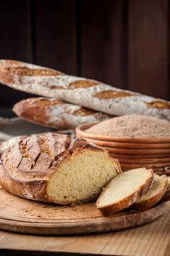 Bread. Baked bread. Craft bakery. Sliced bread on a wooden background. Food b Stock Photos