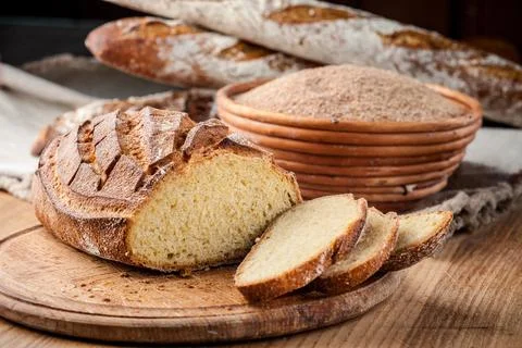 Bread. Baked bread. Craft bakery. Sliced bread on a wooden background. Food b Stock Photos