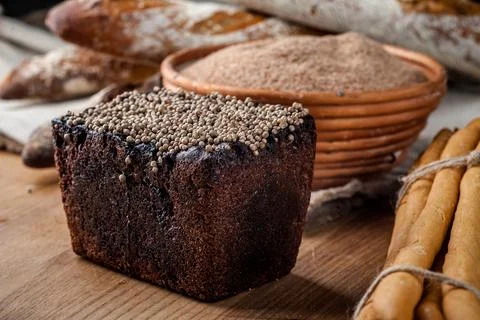 Bread. Baked bread. Craft bakery. Sliced bread on a wooden background. Food b Stock Photos