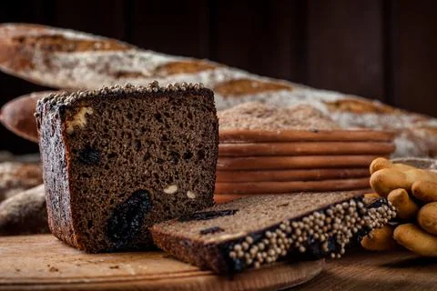 Bread. Baked bread. Craft bakery. Sliced bread on a wooden background. Food b Stock Photos