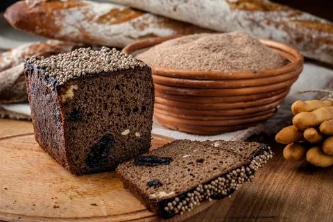 Bread. Baked bread. Craft bakery. Sliced bread on a wooden background. Food b Stock Photos