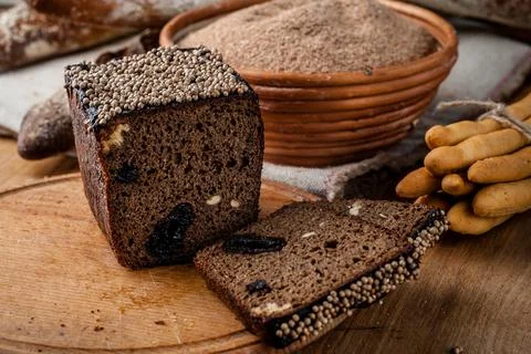 Bread. Baked bread. Craft bakery. Sliced bread on a wooden background. Food b Stock Photos