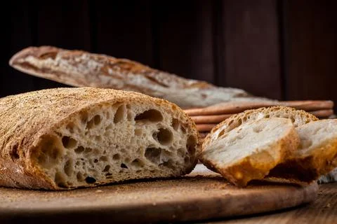 Bread. Baked bread. Craft bakery. Sliced bread on a wooden background. Food b Stock Photos