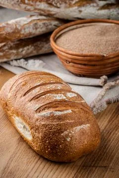 Bread. Baked bread. Craft bakery. Sliced bread on a wooden background. Food b Stock Photos