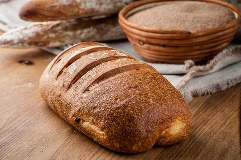 Bread. Baked bread. Craft bakery. Sliced bread on a wooden background. Food b Stock Photos