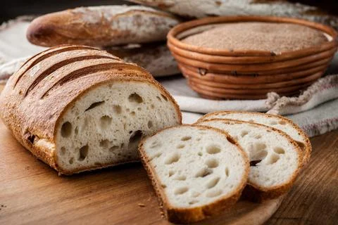 Bread. Baked bread. Craft bakery. Sliced bread on a wooden background. Food b Stock Photos