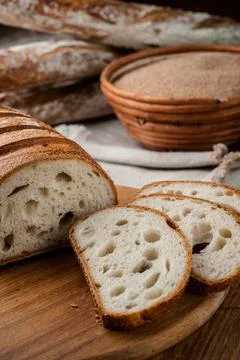 Bread. Baked bread. Craft bakery. Sliced bread on a wooden background. Food b Stock Photos
