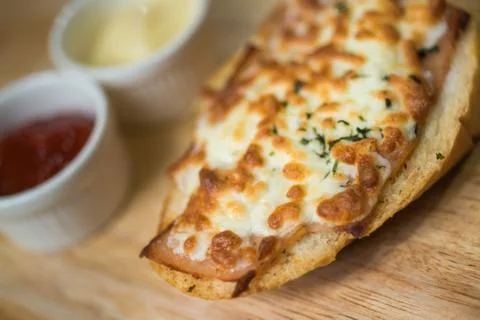 Bread baked with cheese served with tomato sauce, and chili sauce. Stock Photos