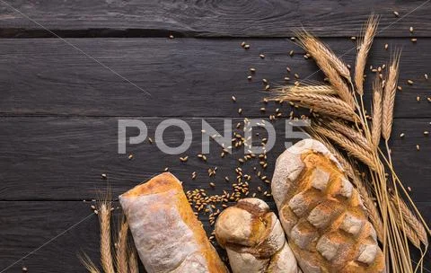 Bread bakery background. Brown and white wheat grain loaves composition Stock Photos