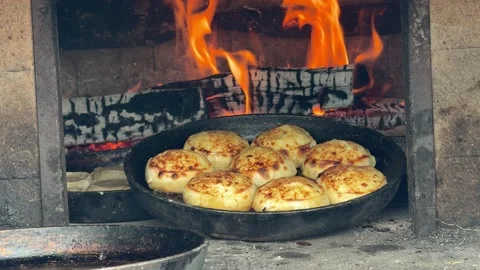 Bread bakes golden in a roaring fireplace oven Stock Footage 345238159