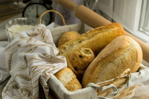 Bread basket decorated with a cloth, on the back of the rolling pin. Stock Photos