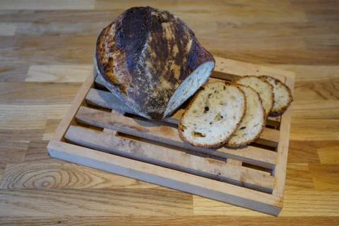 Bread being cut on a cutting board 库存照片