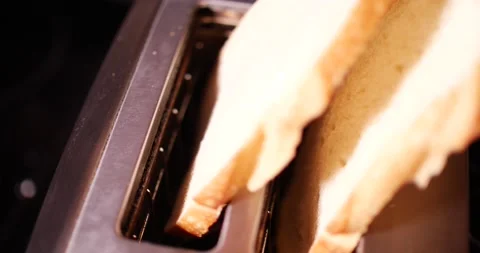 Bread being placed into toaster ready to toast close up Video stock 150606956
