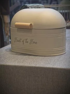 Bread bin on a striped table Stock Photos