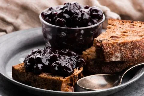 Bread with blueberry jam on the plate Stock Photos