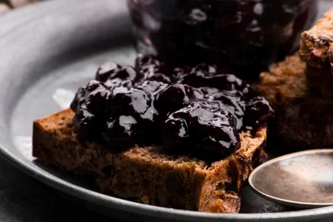 Bread with blueberry jam on the plate Stock Photos