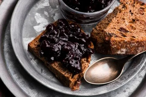 Bread with blueberry jam on the plate Stock Photos