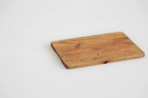 Bread board on white surface background Stock Photos