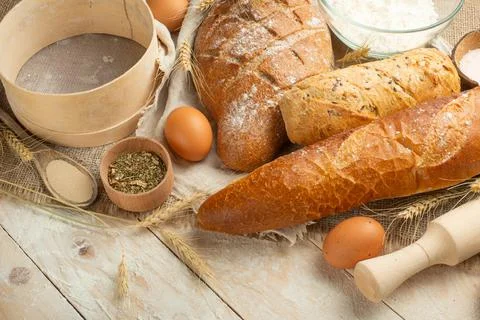 Bread border on a wood background with copy space. Brown and white whole grai Stock Photos