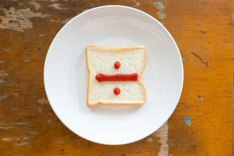 Bread of breakfast is written Divide sign by ketchup on write plate. A to Z a Stock Photos