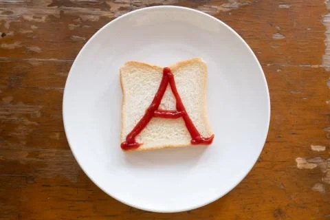 Bread of breakfast is written A by ketchup on write plate. A to Z and Number  Stock Photos