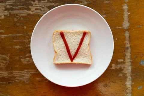Bread of breakfast is written V by ketchup on write plate. A to Z and Number  Stock Photos