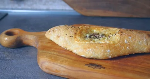 Bread bun baked in the oven with cheese on a wooden board with spices Stock Footage 274841386