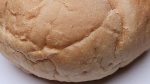 Bread bun rotating in close macro view presented as seamless loop for food .. Video stock 323237756