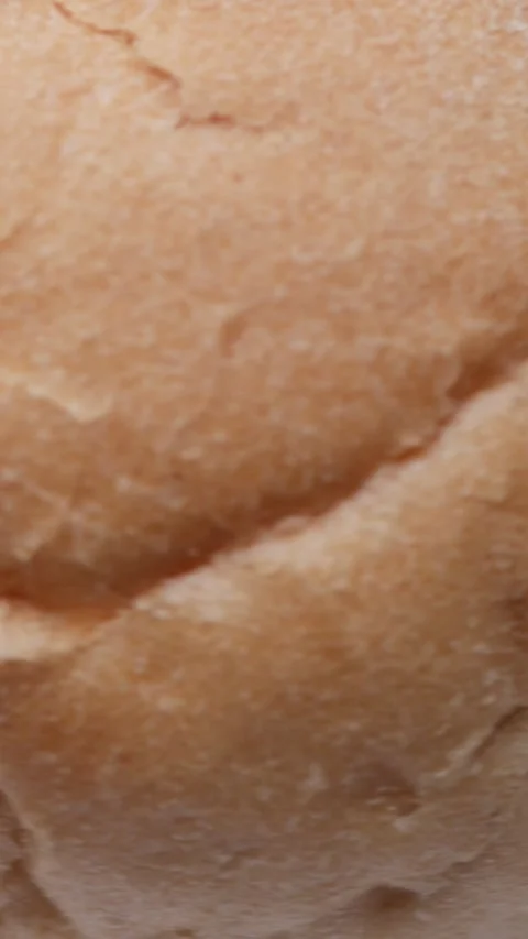 Bread bun rotating in macro closeup presented as seamless loop for food stock Video stock 323333179
