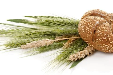 Bread bun with wheat spikes Stock Photos