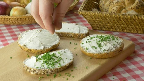 Bread buns with cream cheese sprinkled with chives Stockbeeldmateriaal 107538359