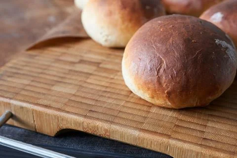 Bread buns on a cutting board. Stock Photos