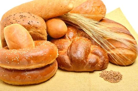 Bread, buns, rolls on the tablecloth isolated on white Stock Photos