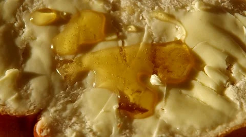 Bread with butter and honey Stock Footage 56525077