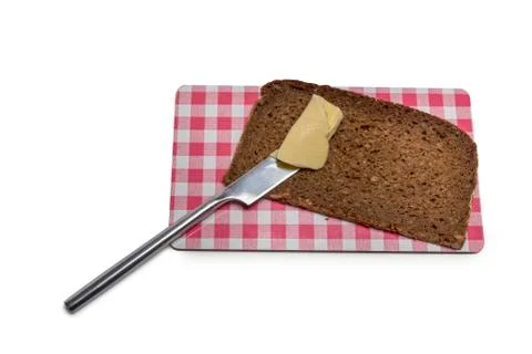 Bread with butter on a board Stock Photos
