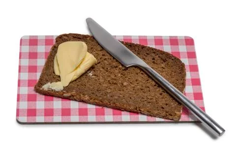 Bread with butter on a board Stock Photos