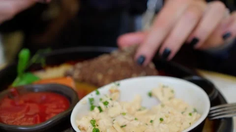 Bread with butter. Knife smearing soft butter on slice of bread, c Stock Footage 246733444