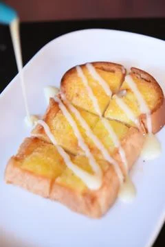 Bread with butter in plate Stock Photos