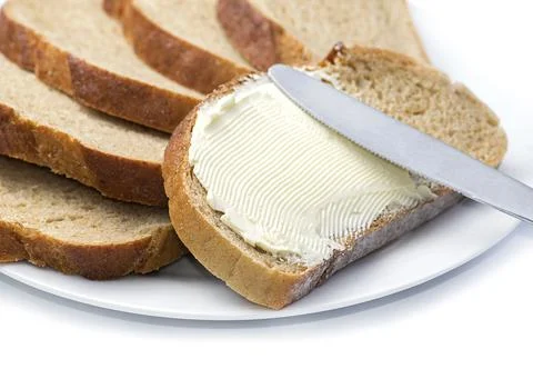 Bread with butter. Simple breakfast concept. Stock Photos