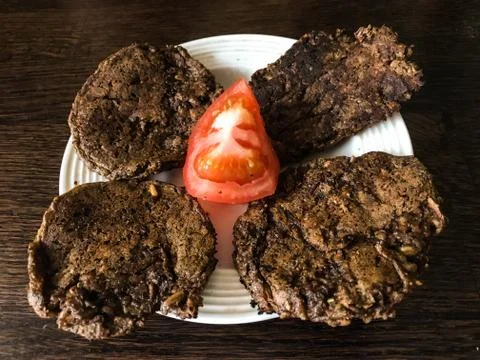 Bread cakes with tomato on a plate Stock Photos