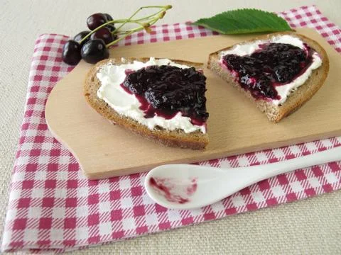 Bread with cherry jam Stock Photos