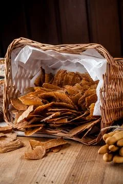 Bread chips. Basket with chips. Scattered crispy pastries. Chips in a wooden Stock Photos