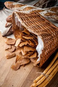 Bread chips. Basket with chips. Scattered crispy pastries. Chips in a wooden Stock Photos