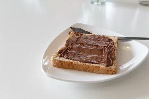 Bread with chocolate cream on the table Stock Photos