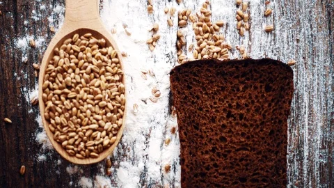 Bread composition on a table with grain and flour. Stock Footage 116153255