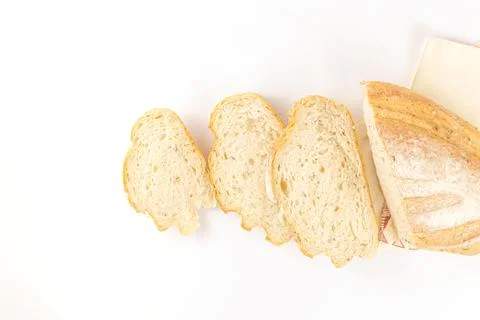 Bread concept a few slices of bread and a half loaf of bread on the white bac Stock Photos
