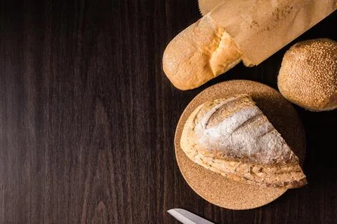 Bread concept a half loaf of bread on the wooden plate, a loaf of bread into Stock Photos