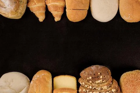 Bread concept loaves of bread, buns, slices of bread with seeds, and croissan Stock Photos