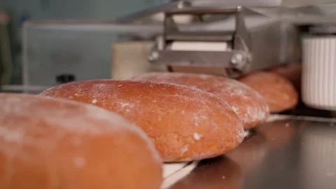 Bread on a conveyor belt close up. Slow motion Stock Footage 250273819