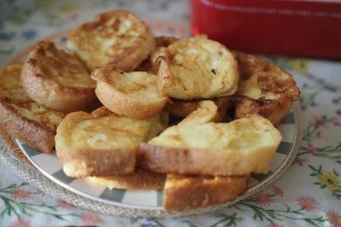 Bread is cooked and served on a plate during breakfast time Stock Photos